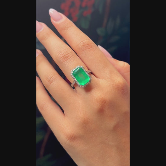 Emerald rubover diamond surround ring